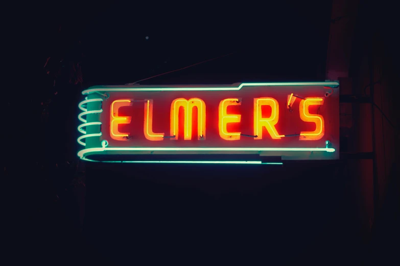 a neon sign hanging from the side of a building, by Everett Warner, pexels contest winner, international typographic style, elmo, slimmer demeanor, elves, 1950s photograph