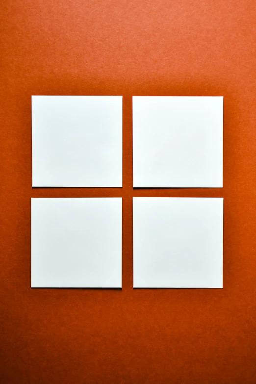 four squares of white paper on an orange background, inspired by Ellsworth Kelly, unsplash, 2 5 6 x 2 5 6, made of all white ceramic tiles, microsoft windows, red wall