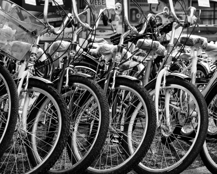 a bunch of bikes parked next to each other, a photo, by Hans Schwarz, pexels, process art, white wheel rims, black white, educational, featured