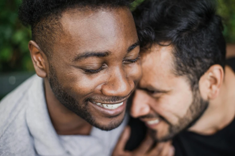 a couple of men standing next to each other, trending on unsplash, kissing smile, varying ethnicities, close up portrait photo, thumbnail