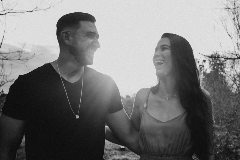 a man and a woman standing next to each other, a black and white photo, by Kristian Zahrtmann, pexels, adriana chechik, smiling playfully, kailee mandel, background image