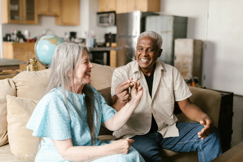 a man and a woman sitting on a couch, pexels contest winner, joints, old lady screaming and laughing, sitting on man's fingertip, varying ethnicities