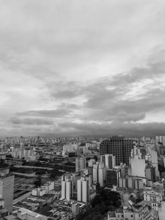 a black and white photo of a city, by Joze Ciuha, são paulo, cinematic. by leng jun, high quality image”, patches of sky