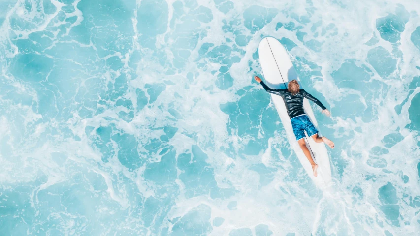 a man riding a surfboard on top of a wave, pexels contest winner, smiling down from above, shades of blue, various posed, ocean spray