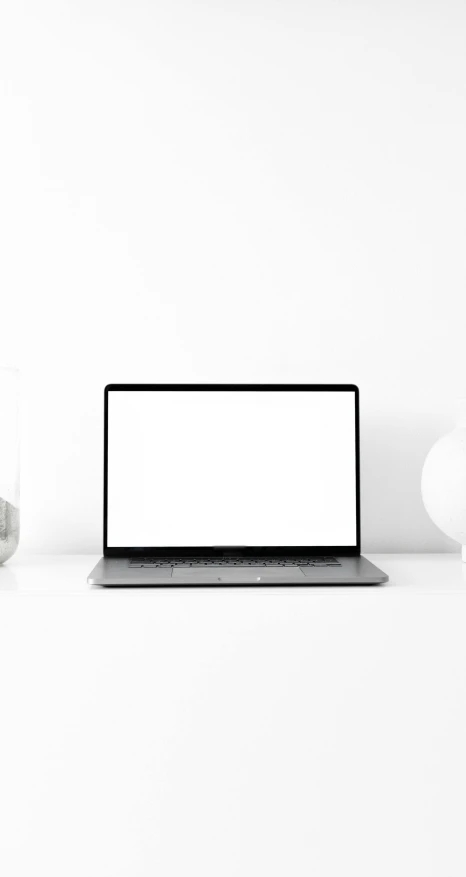 a laptop computer sitting on top of a white desk, minimalism, thumbnail, product introduction photo