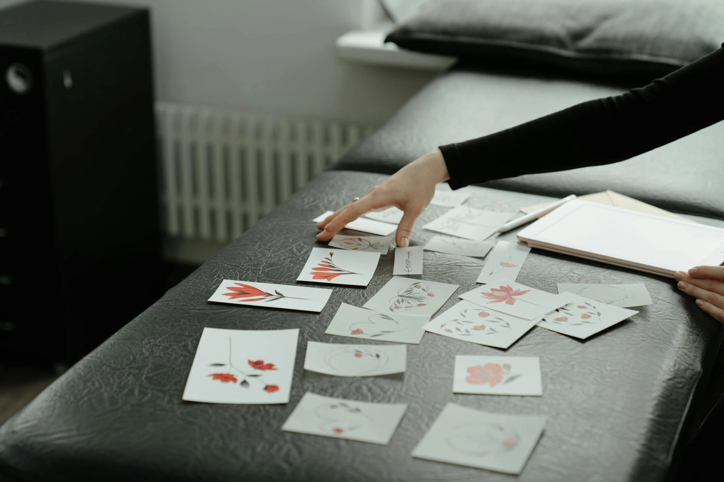 a person playing a game of cards on a table, a drawing, by Emma Andijewska, pexels contest winner, process art, falling red petals, minimal modern pixel sorting, stickers, soft grey and red natural light