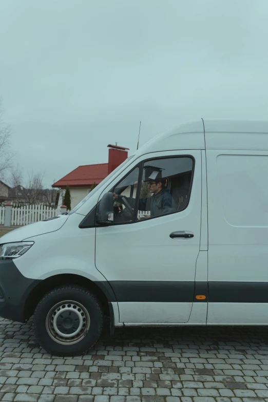 a white van parked on a cobblestone road, b - roll, in russia, non-binary, delivering mail