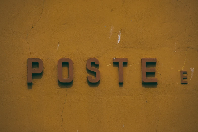 a close up of a sign on a wall, a poster, pexels contest winner, postminimalism, brown, postage, profile image, foster
