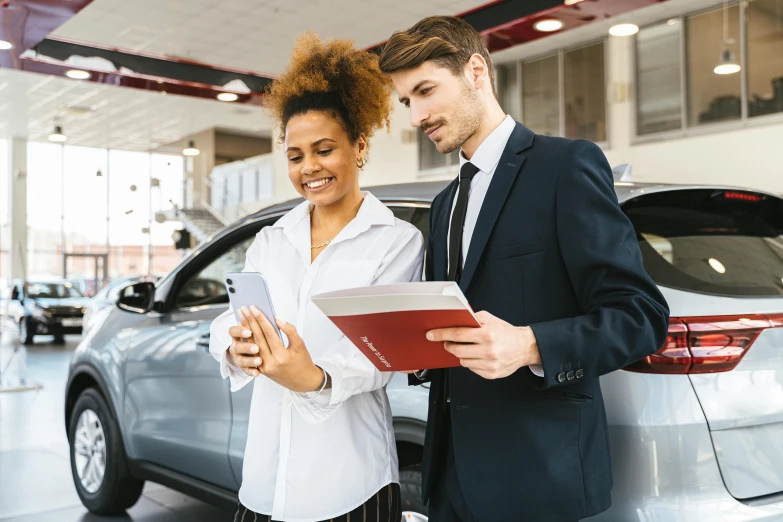 a man and woman looking at a car in a dealers showroom, pexels contest winner, renaissance, thumbnail, multiple stories, selling insurance, full colour