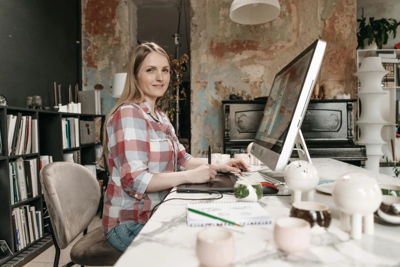 a woman sitting at a table working on a computer, a portrait, by Jacqui Morgan, pexels contest winner, casual pose, 15081959 21121991 01012000 4k, thumbnail, digital image