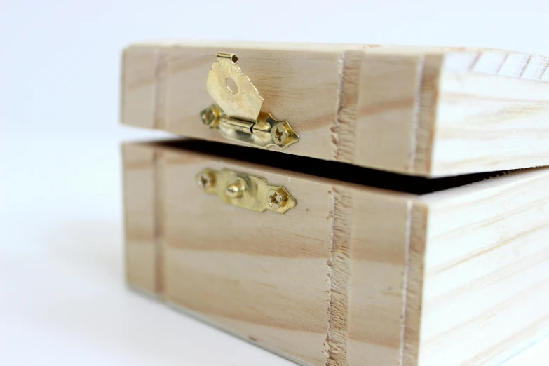 a wooden box sitting on top of a table, set against a white background, crafting, golden detailing, 4 0 mm