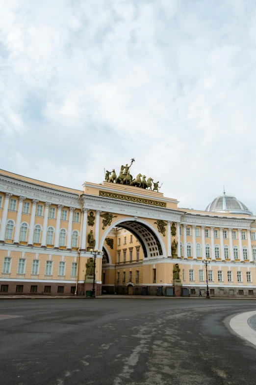 a large building with a clock on top of it, inspired by Illarion Pryanishnikov, neoclassicism, archway, russian flags, the palace of ai, a middle-shot from front