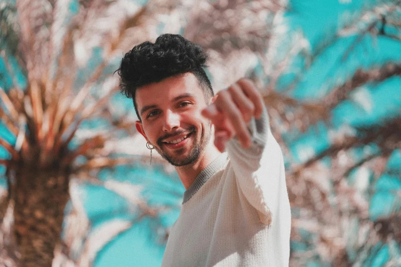 a man standing in front of a palm tree, an album cover, by Adam Dario Keel, pexels contest winner, antipodeans, giving a thumbs up to the camera, smiling :: attractive, youtuber, profile picture 1024px