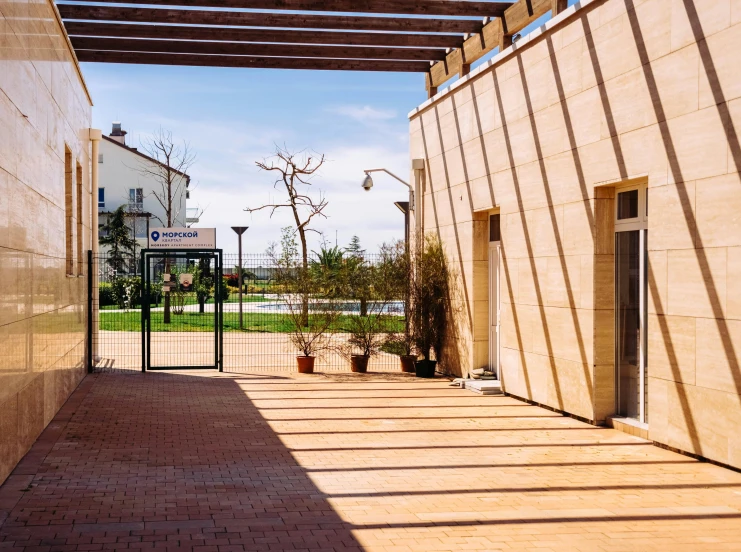 a walkway between two buildings on a sunny day, by Gavin Hamilton, danube school, in spain, patio, entrance, featured