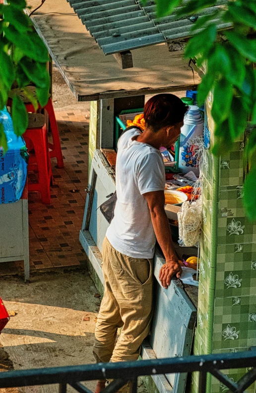 a couple of men standing next to each other, happening, food stall, cambodia, vending machine, at sunrise