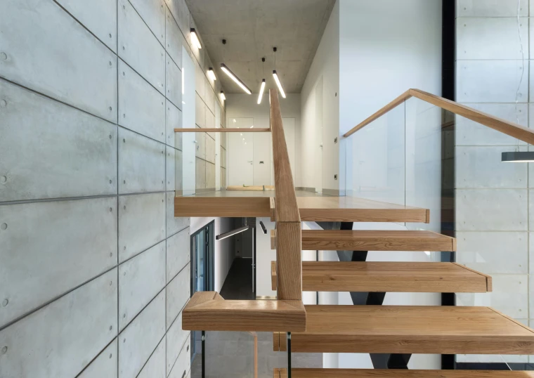 a set of wooden stairs next to a wall, inspired by Heinrich Bichler, unsplash, modernism, concrete steel glass, gallery lighting, oak, full-shot