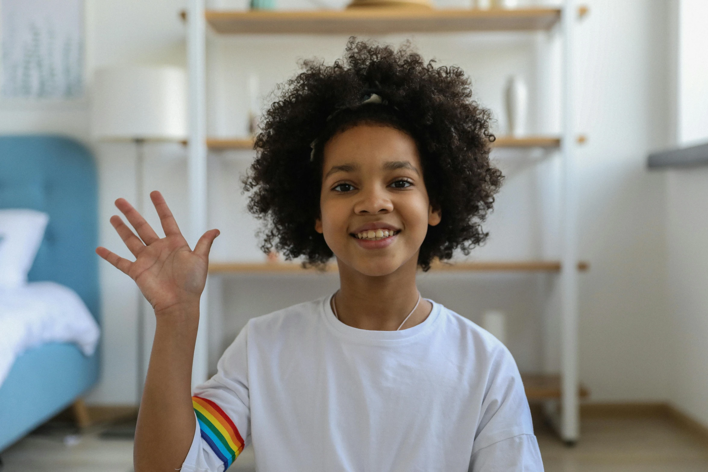 a little girl sitting on the floor with her hands in the air, pexels contest winner, with afro, future coder, wave a hand at the camera, aboriginal