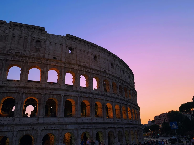 the sun sets behind the colossion in rome, pexels contest winner, purple hues, in a coliseum, profile image, exterior