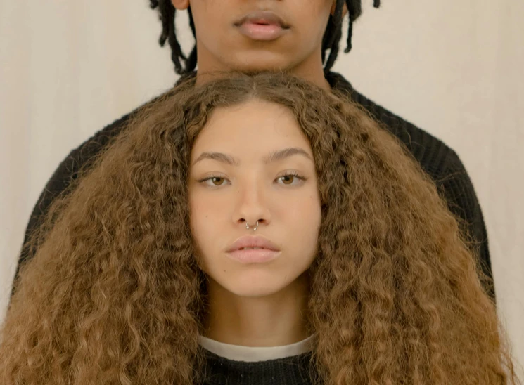 a man standing next to a woman with long hair, trending on pexels, portrait sophie mudd, ashteroth, courtesy of moma, detailled face