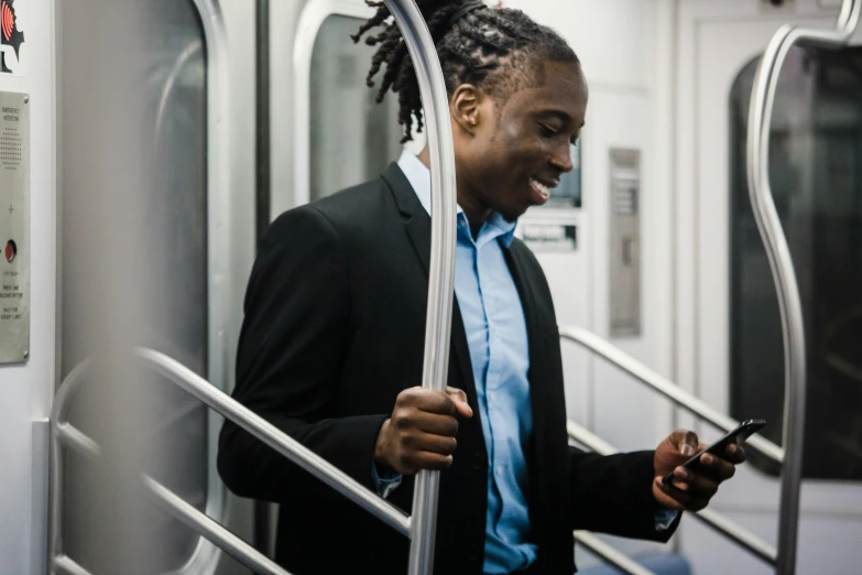 a man in a suit looking at his cell phone, by Carey Morris, pexels contest winner, blue dreadlocks, subways, professional profile picture, avatar image