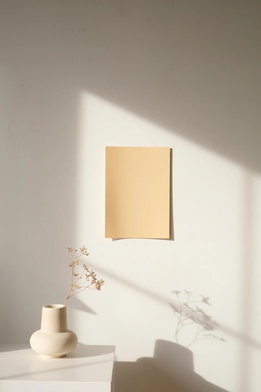 a vase sitting on top of a white table, a minimalist painting, postminimalism, sunny amber morning light, layered paper, detailed product image, light - brown wall