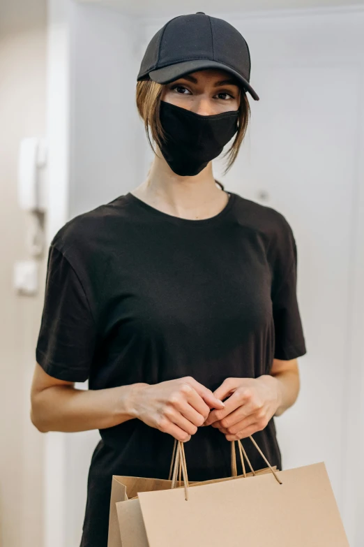 a woman wearing a face mask holding a shopping bag, wearing a black t-shirt, smooth details, featured face details, 奈良美智