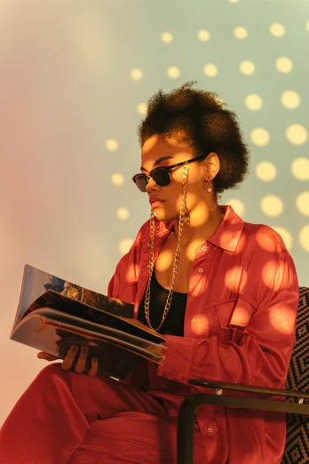 a woman sitting on a chair reading a book, an album cover, trending on pexels, funk art, with sunglass, flashing lights, afro, profile portrait