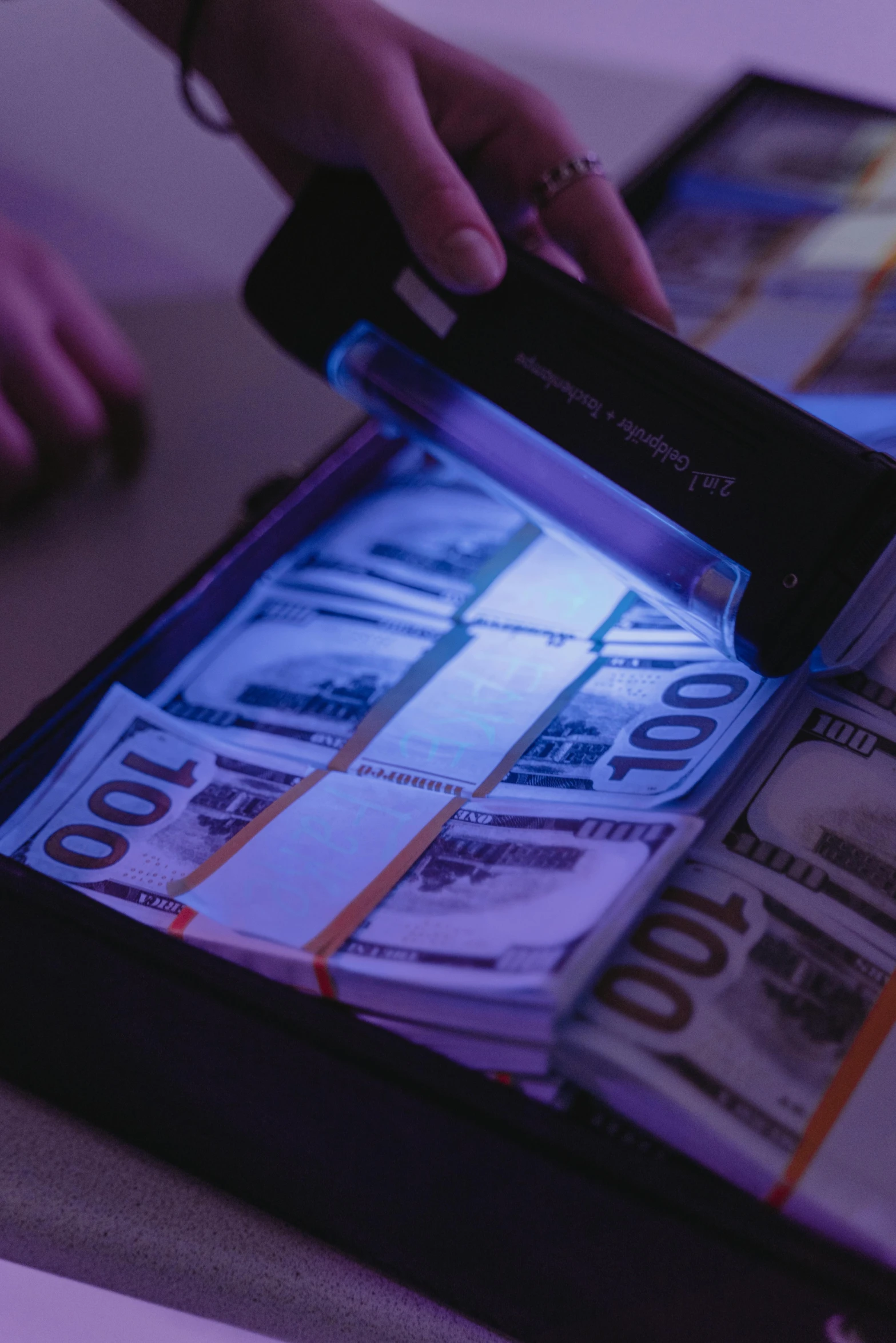 a suitcase filled with lots of money sitting on top of a table, a hologram, by Byron Galvez, pexels contest winner, holography, kevin mitnick as a bank robber, black light, thumbnail, fbi