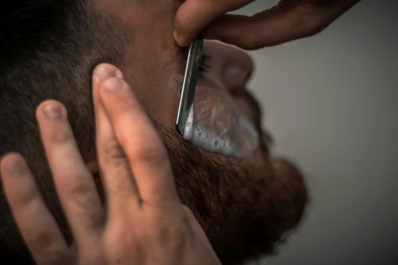 a man shaving his beard with a cell phone, pexels contest winner, hyperrealism, square masculine facial features, paul barson, crew cut, thumbnail