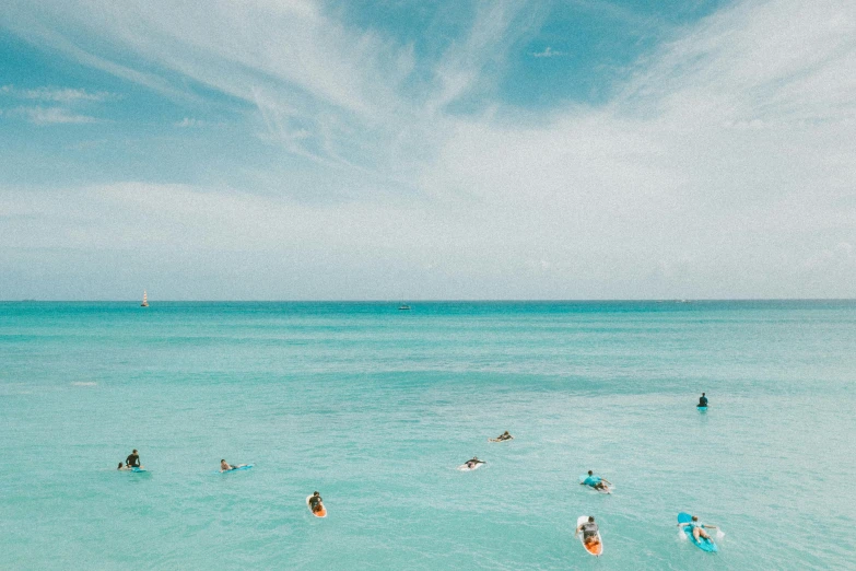 a group of people swimming in the ocean, turquoise ocean, no watermarks, unsplash photography, 🦩🪐🐞👩🏻🦳