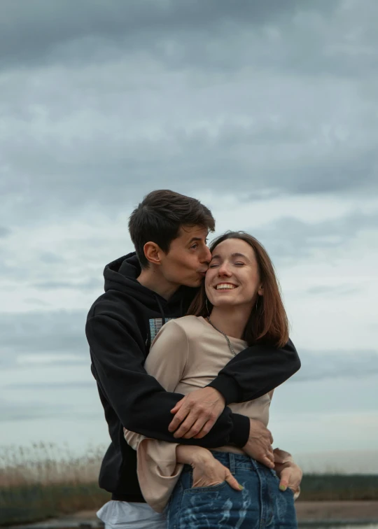 a man and a woman hugging in front of a body of water, pexels contest winner, pokimane, happy clouds behind, profile image, russian girlfriend