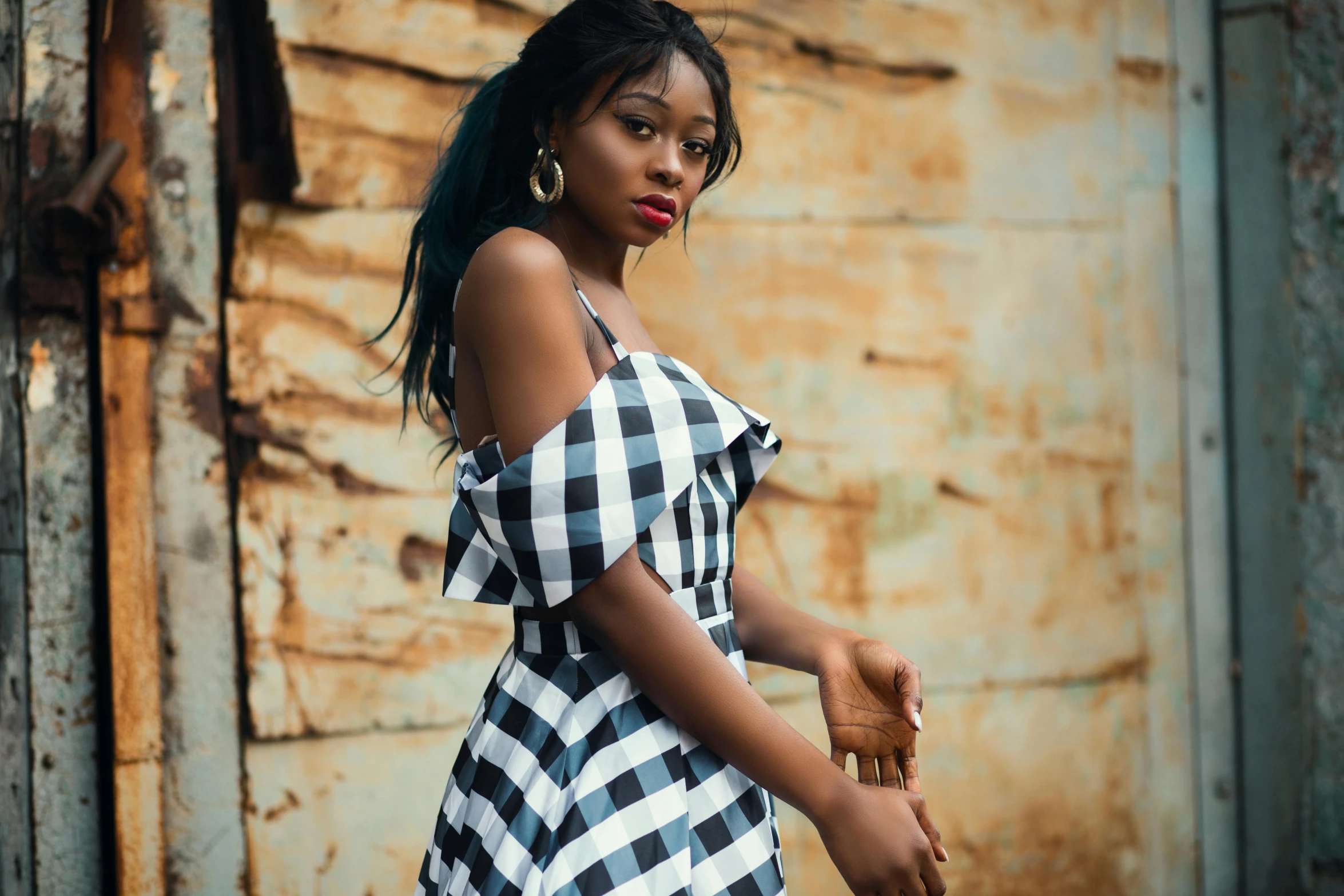 a woman in a black and white checkered dress, by Chinwe Chukwuogo-Roy, trending on pexels, renaissance, square, black teenage girl, old fashion, white and teal garment