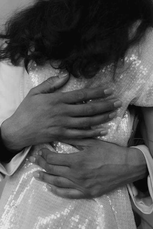 a black and white photo of a man hugging a woman, inspired by Nan Goldin, romanticism, detailed hands, wearing a sparkling dress, imaan hammam, ignant