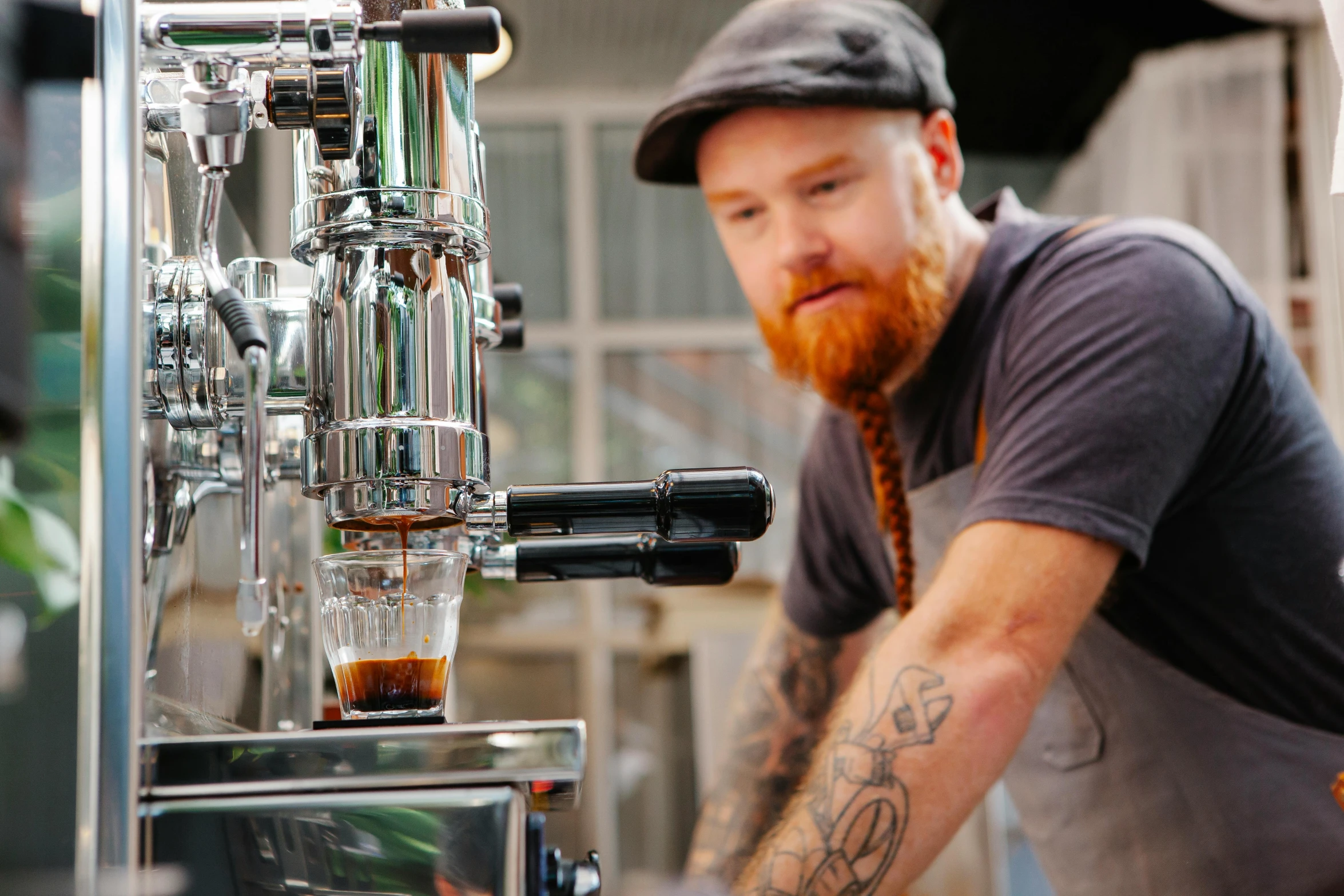 a man standing in front of a coffee machine, pexels contest winner, braided beard redhead dreadlocks, aussie baristas, pouring techniques, very crisp details