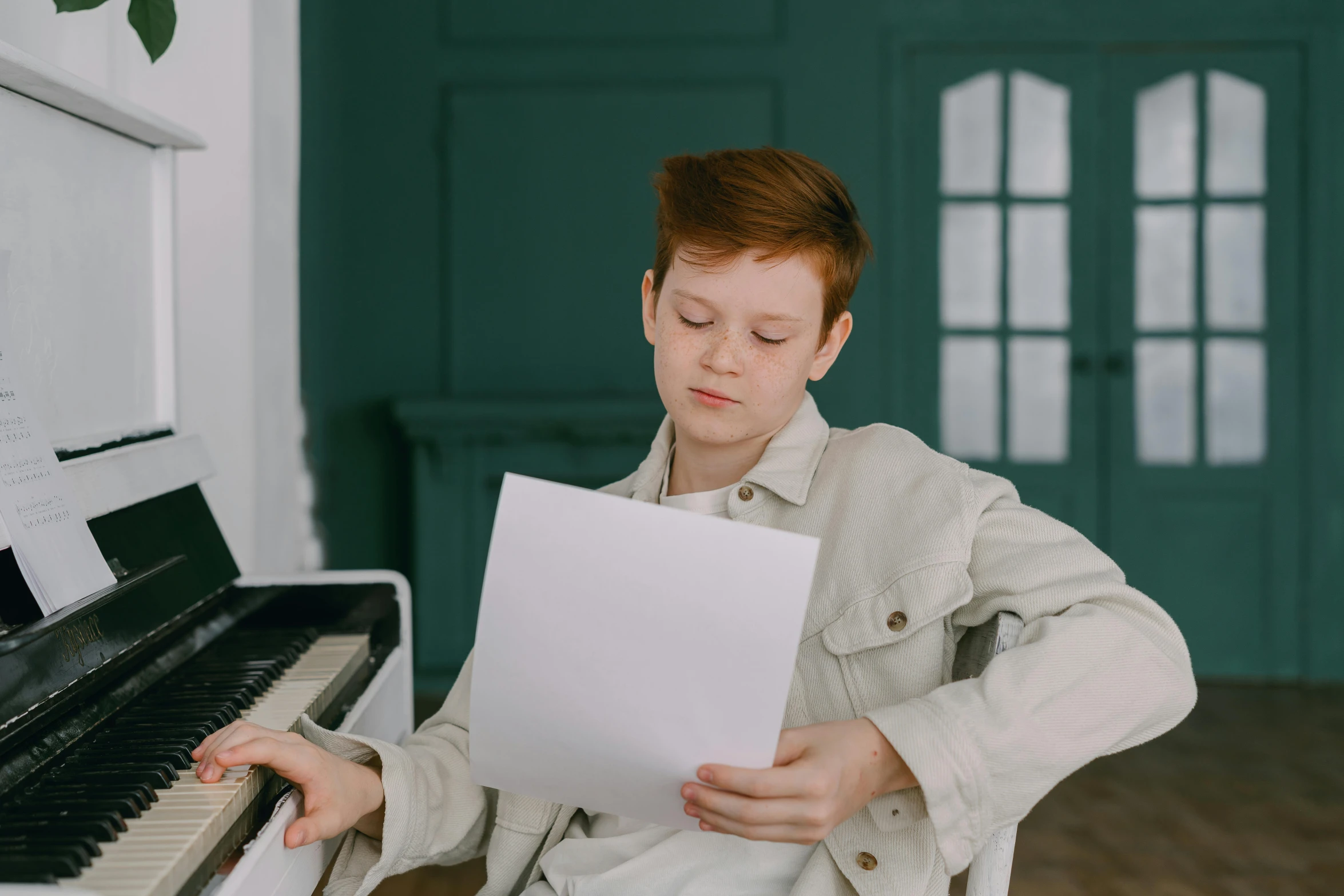 a boy sitting at a piano reading a sheet of paper, trending on pexels, a redheaded young woman, with a white complexion, boy with neutral face, proportional image