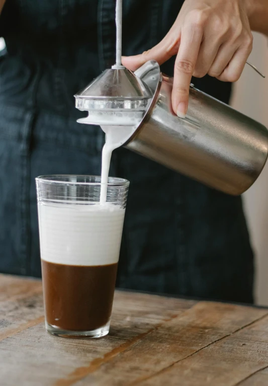 a person pouring a drink into a glass, milk and mocha style, professionally assembled, short spout, thumbnail