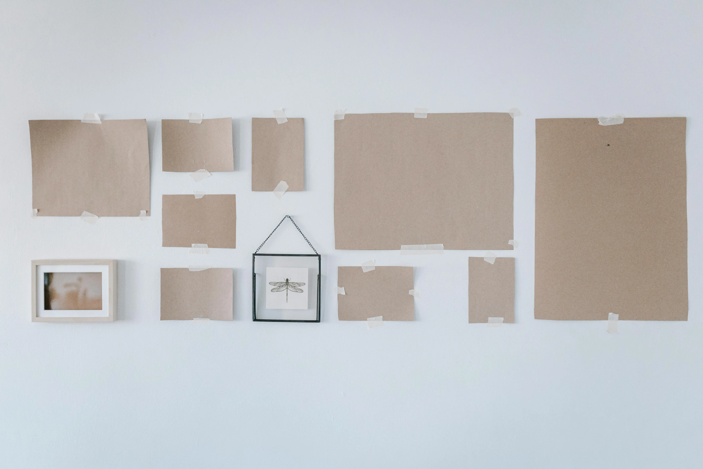 a room with several pieces of cardboard on the wall, a minimalist painting, pexels contest winner, for displaying recipes, whitespace border, home display, white wall