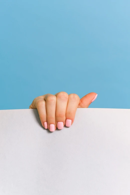 a woman's hand holding a piece of paper, trending on pexels, aestheticism, shades of pink and blue, unclipped fingernails, ilustration, arched back