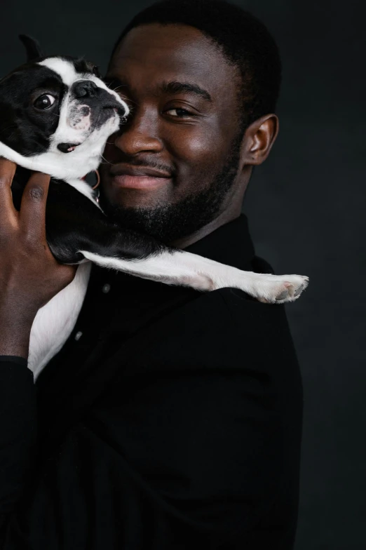 a man holding a dog in his arms, an album cover, pexels contest winner, ( ( dark skin ) ), tuxedo cat, yasuke 5 0 0 px models, headshot profile picture