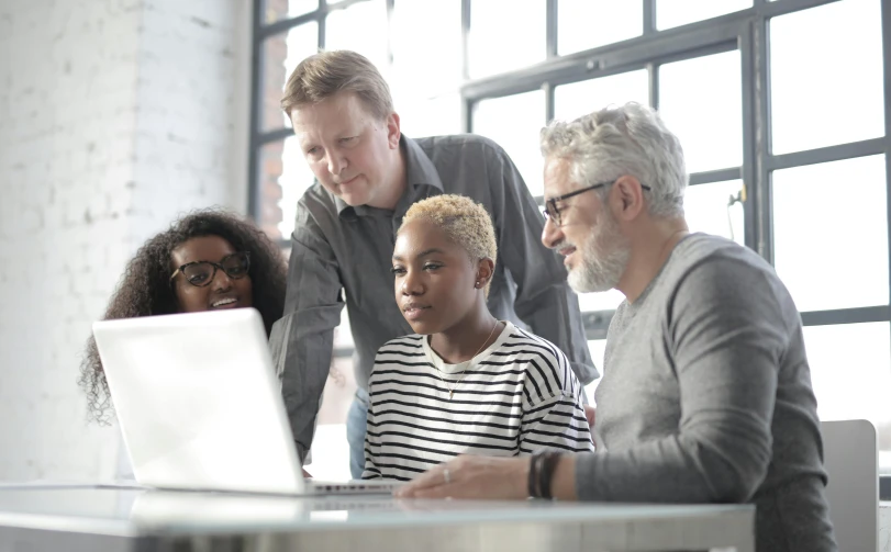 a group of people gathered around a laptop, by Sam Black, pexels, renaissance, future coder man looking on, grey, thancred waters, varying ethnicities