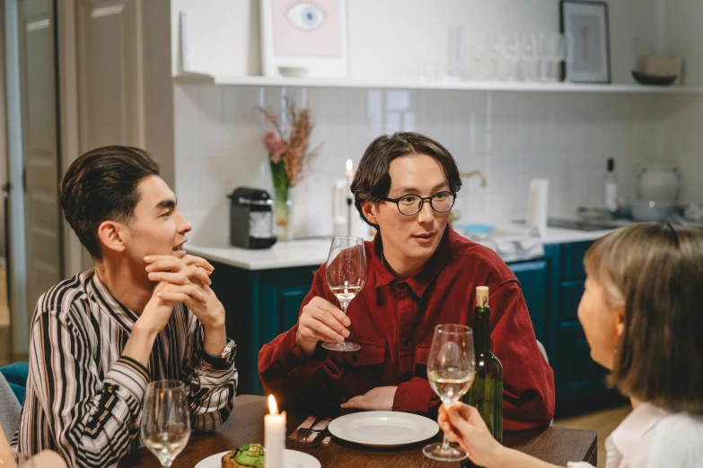 a group of people sitting around a table drinking wine, profile image, non binary model, scandinavian, single subject