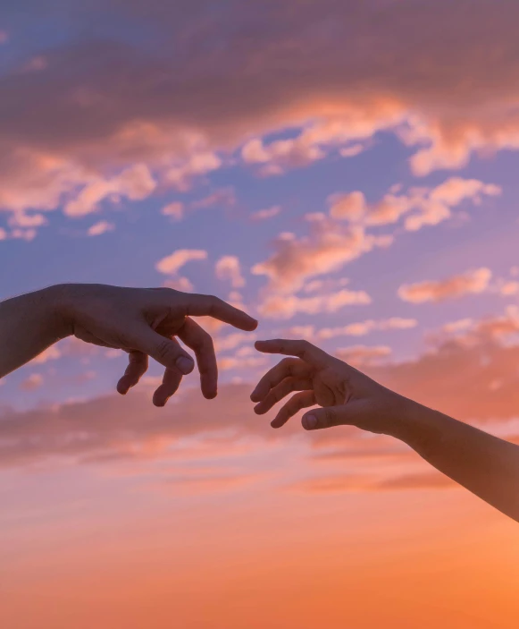 two hands reaching for each other in front of a sunset, by Carey Morris, trending on pexels, pink skies, interconnected human lifeforms, floating in the sky, holding a 🛡 and an 🪓