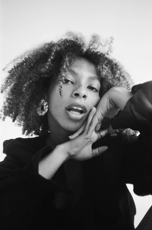 a black and white photo of a woman with curly hair, a black and white photo, by Dulah Marie Evans, trending on pexels, black arts movement, playboi carti portrait, with index finger, sun yunjoo, caramel