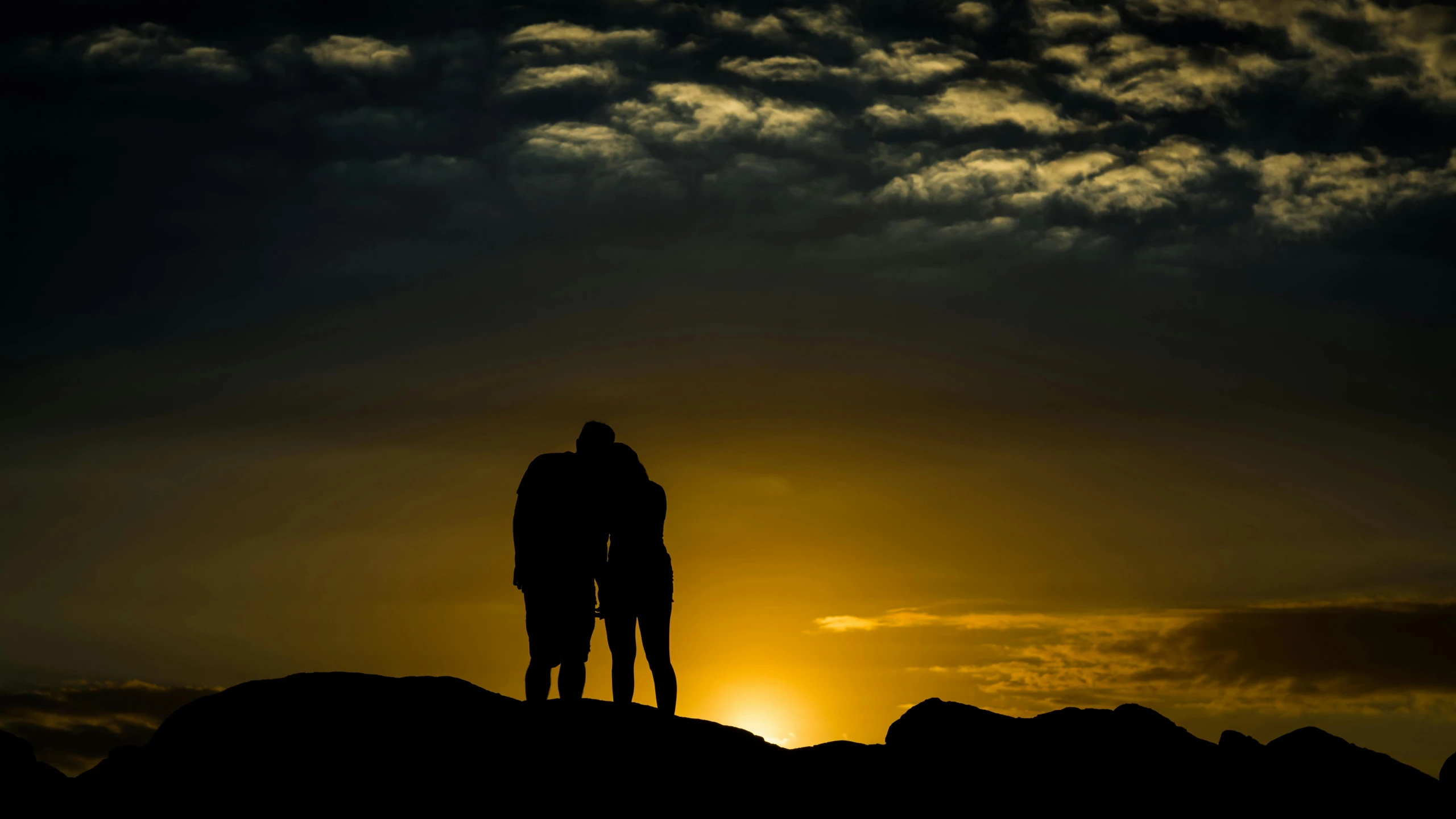 a couple of people standing on top of a mountain, by Jesper Knudsen, pexels contest winner, romanticism, silhoutte, precious moments, loving embrace, end of day