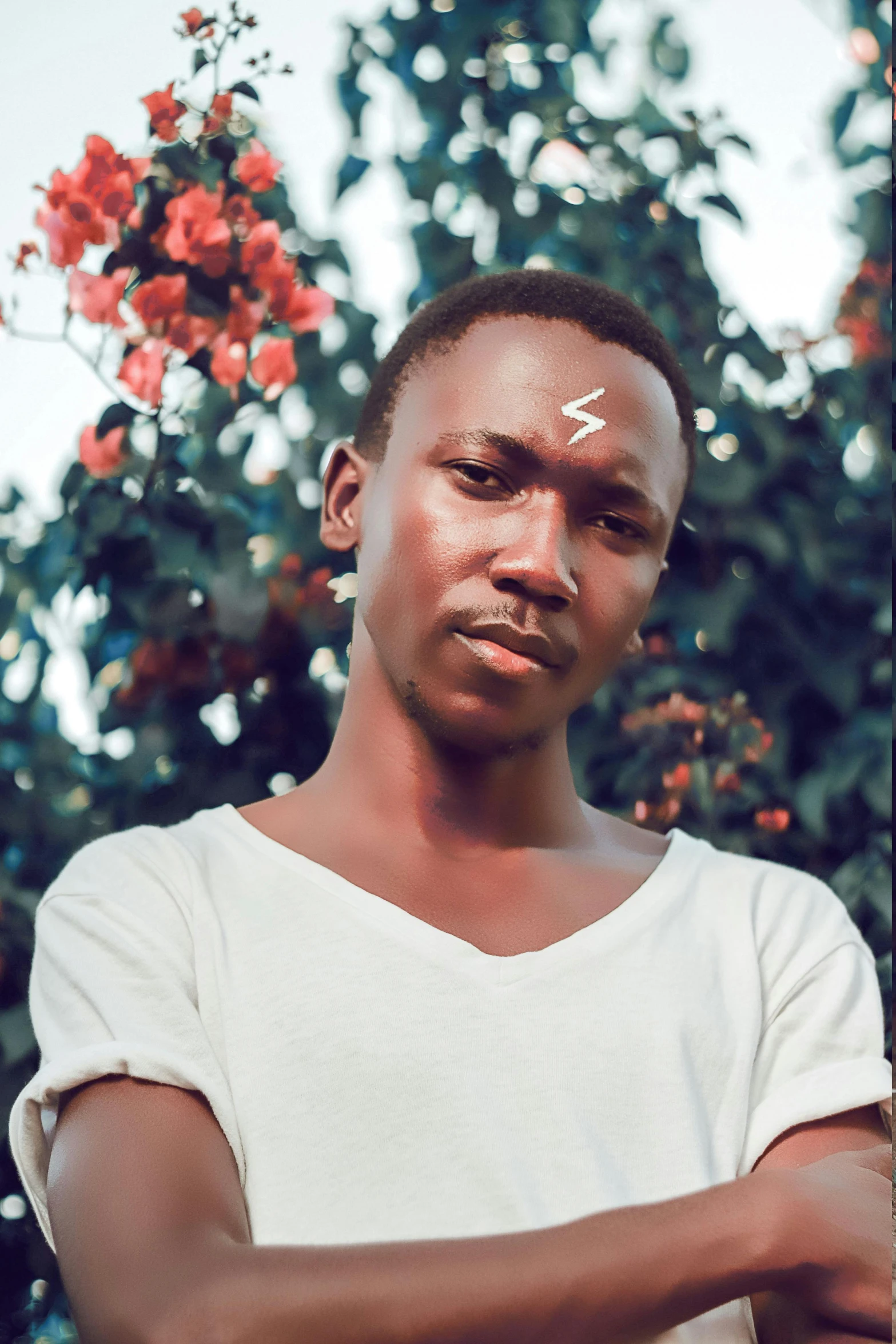 a young man standing in front of a tree, an album cover, inspired by Barthélemy Menn, trending on pexels, hyperrealism, shaven face, lightening, very kenyan, headshot profile picture