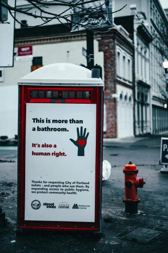 a red fire hydrant sitting on the side of a road, a poster, by Julia Pishtar, unsplash contest winner, street art, commercial washroom hand dryer, raised fist, portland oregon, human heart
