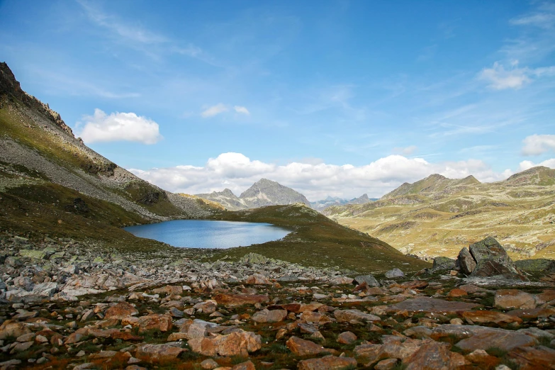 a large body of water sitting on top of a rocky hillside, by Werner Andermatt, pexels contest winner, hurufiyya, mountain lakes, conde nast traveler photo, looking onto the horizon, jacqueline e