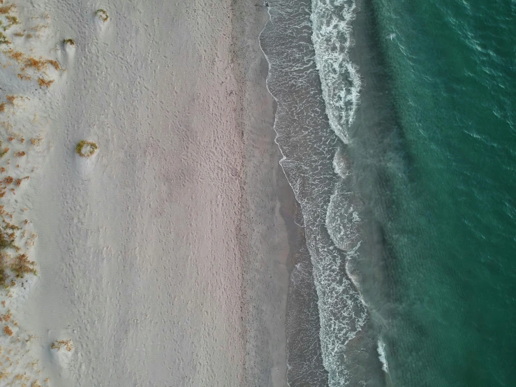 a large body of water next to a sandy beach, unsplash contest winner, birdeye, sea foam, flight, two colors