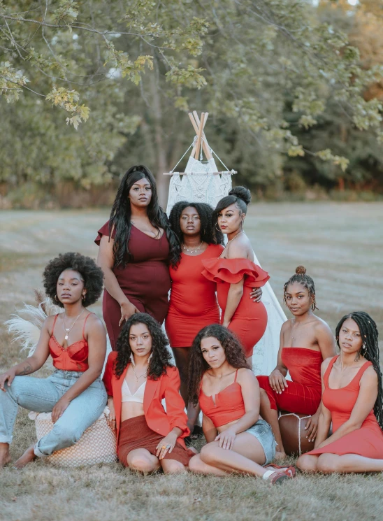 a group of women posing for a picture in a field, by Lily Delissa Joseph, pexels contest winner, black arts movement, wearing a red outfit, brunettes, full product shot, stacked image