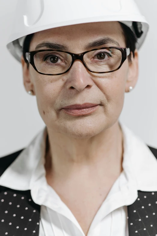 a woman wearing a hard hat and glasses, a character portrait, by Marina Abramović, professional profile photo, wrinkled, portrait image, close up portrait photo